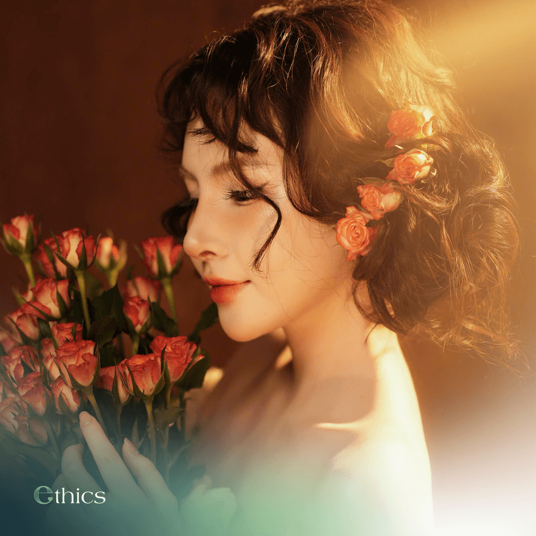 Radiant young female patient holding a bouquet of roses one month after structural rhinoplasty
